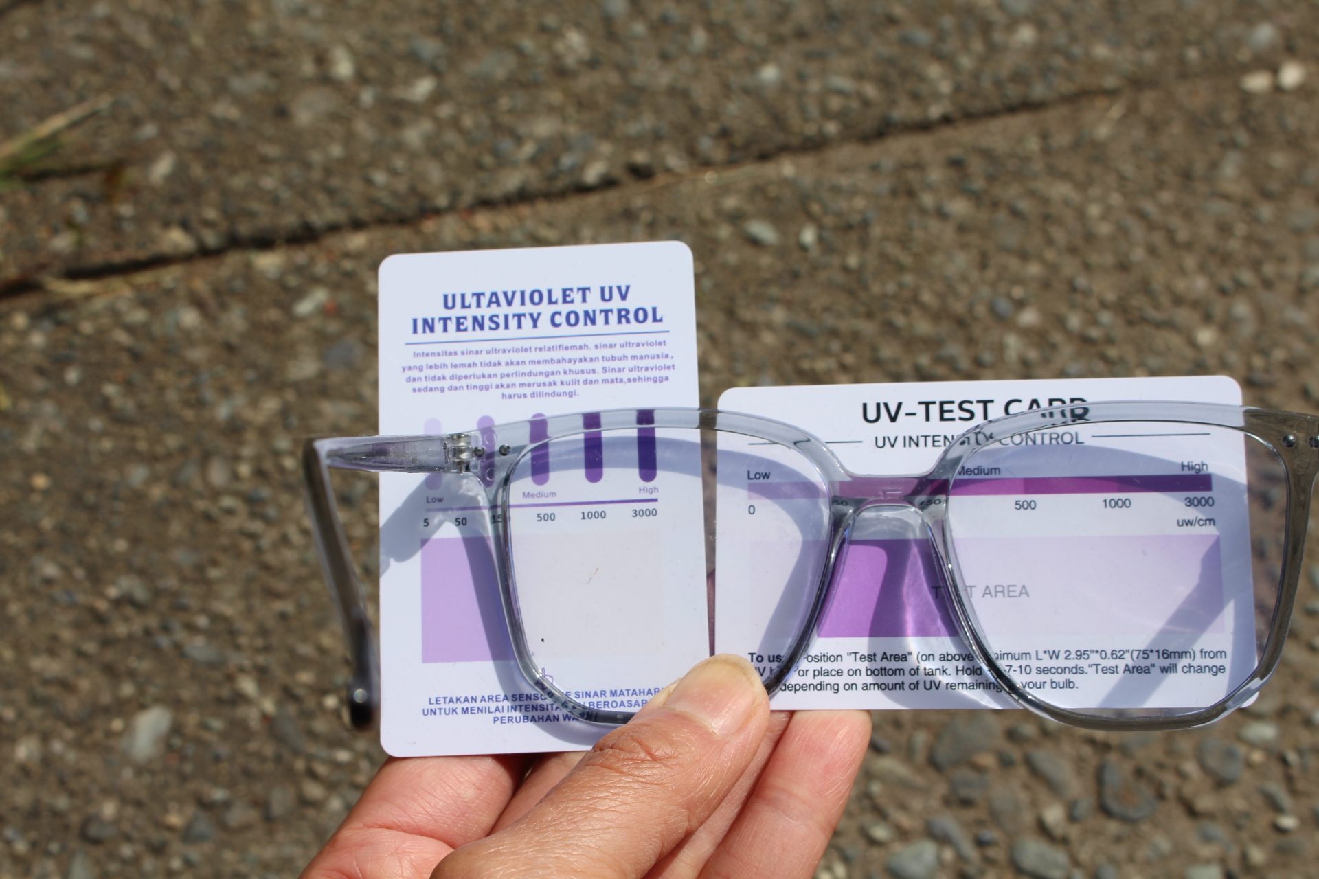 UV-light-blocking test, showing two UV light testers filtered partly by blue-light-blocking glasses