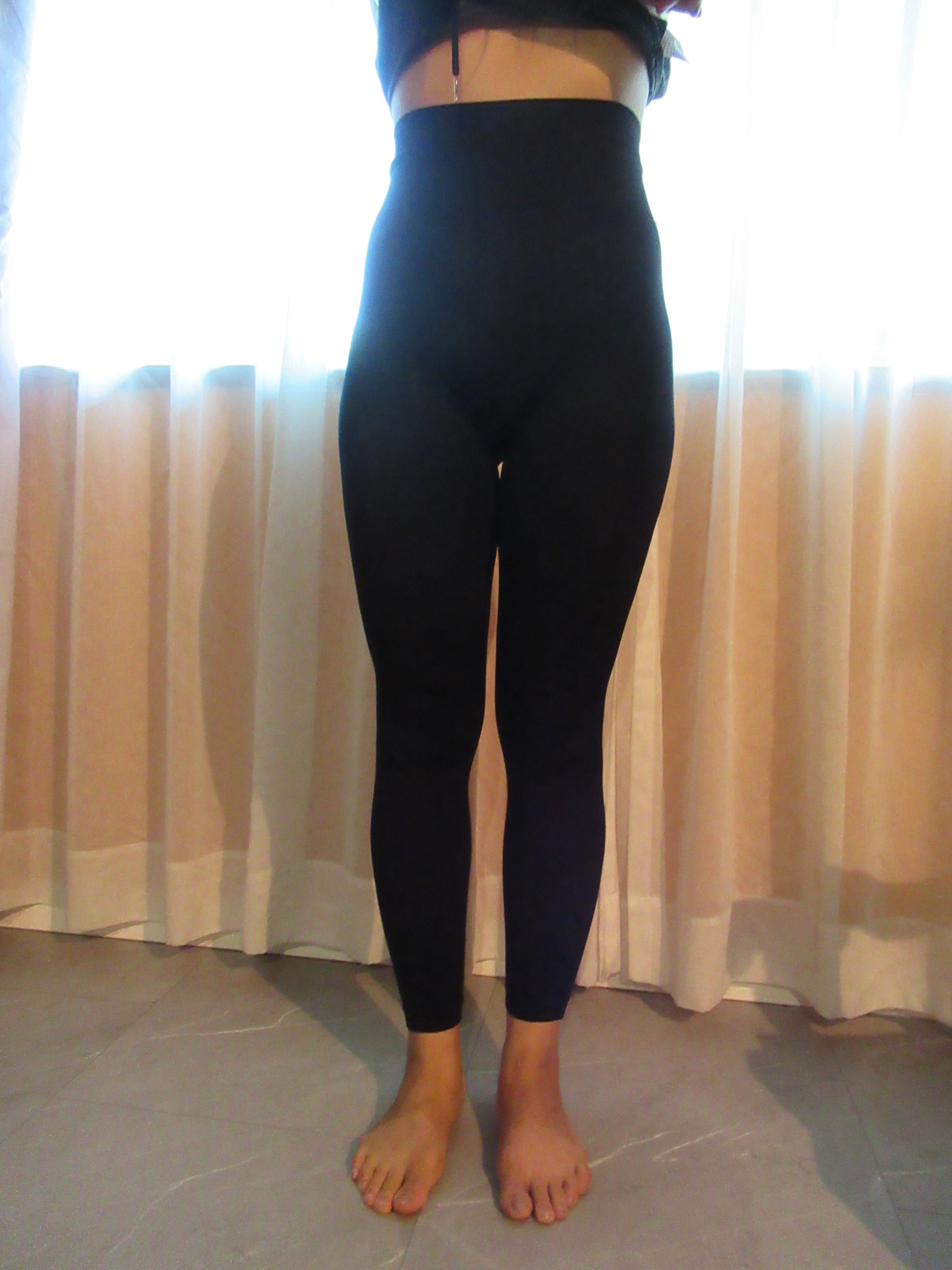 peach lift butt-lifting leggings -- black, front view; trying on, modelling peach-lift butt-lifter on person