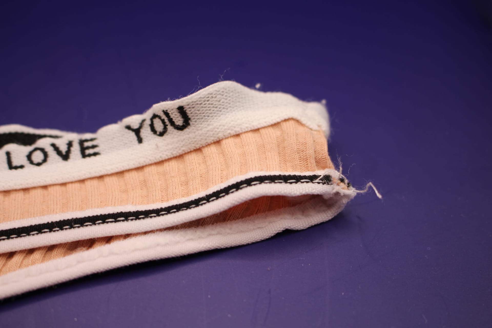 loose thread on peach LOVE YOU panties from Temu