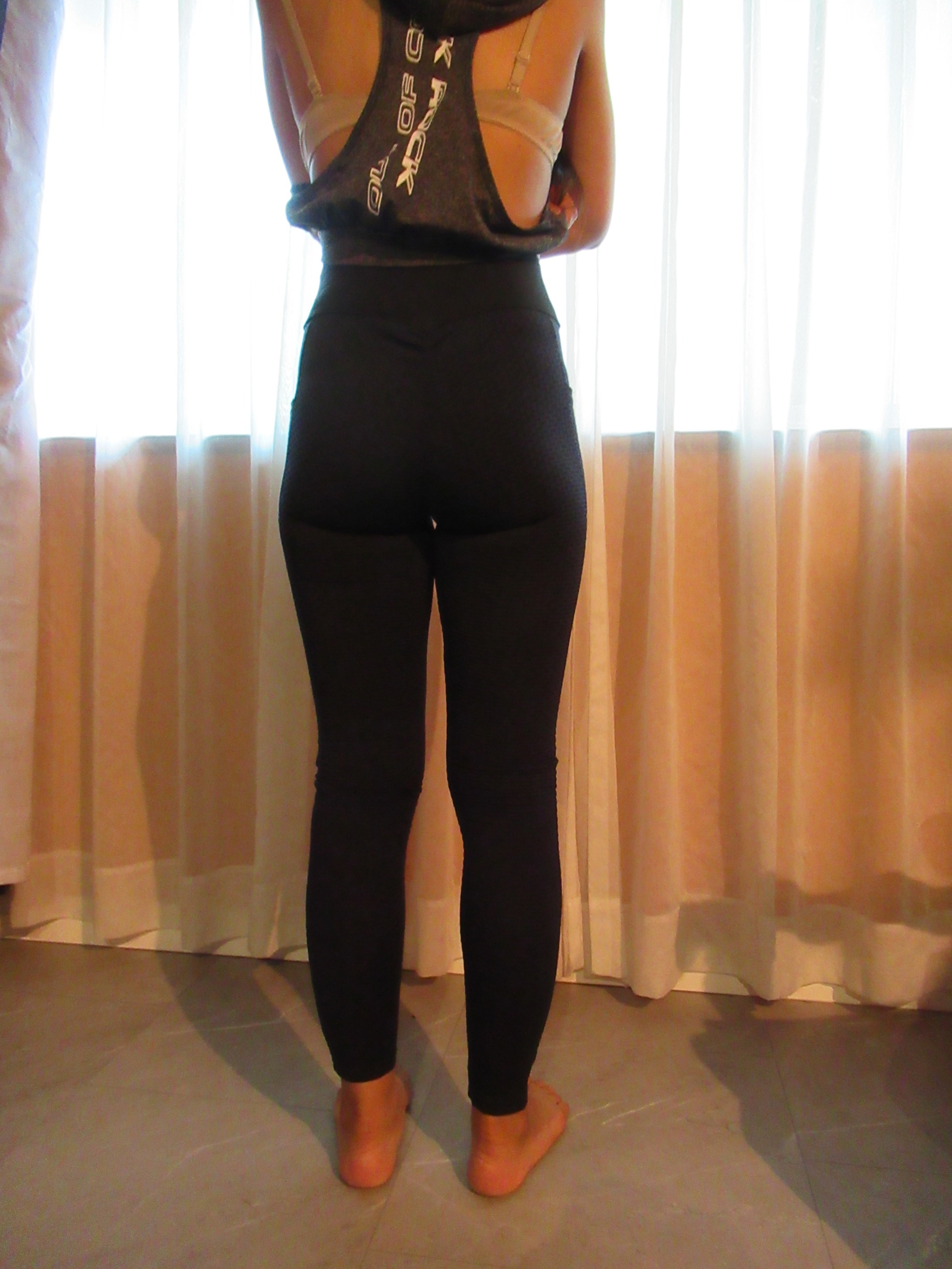 Honeycomb-textured scrunch butt butt-lifting pants -- black, back view; trying on, modelling honeycomb-textured, scrunched butt-lifter on personHoneycomb-textured scrunch butt butt-lifting pants -- black, front view; trying on, modelling honeycomb-textured, scrunched butt-lifter on person