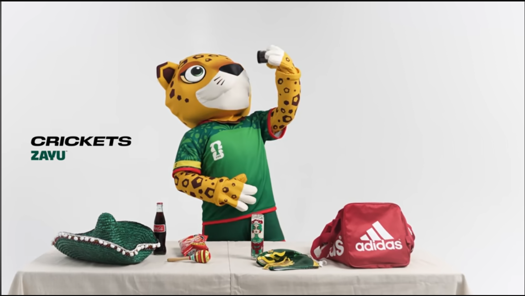 Zayu the Jaguar mascot eating crickets, taken from WHAT'S IN MY BAG? | The Official FIFA World Cup 2026 Mascots YouTube promo video