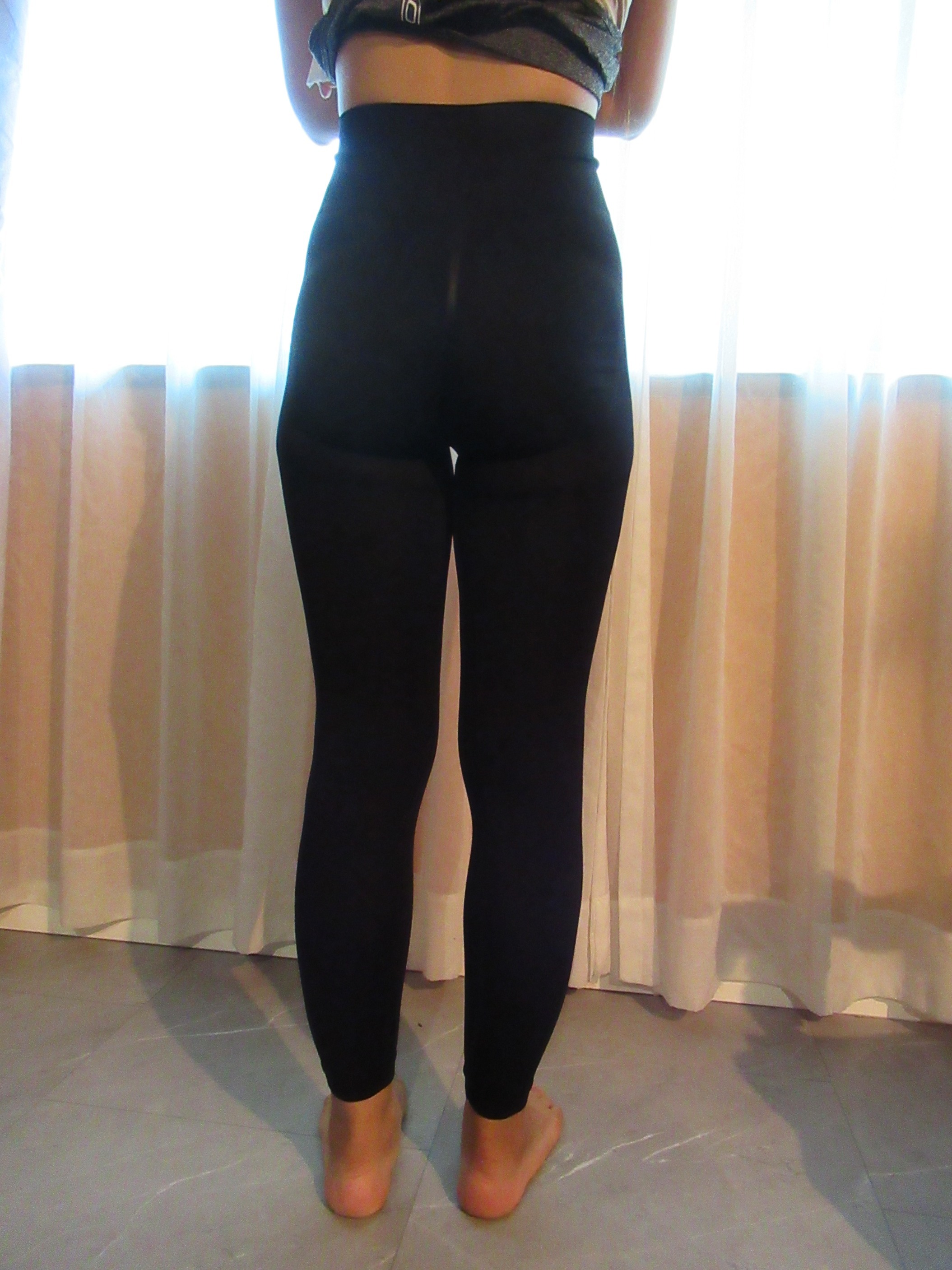 peach lift butt-lifting leggings -- black, back view; trying on, modelling peach-lift butt-lifter on person