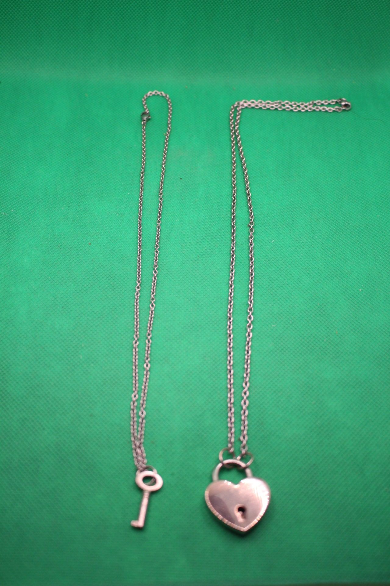 heart lock and key couple necklaces; side by side comparison showing different chain lengths