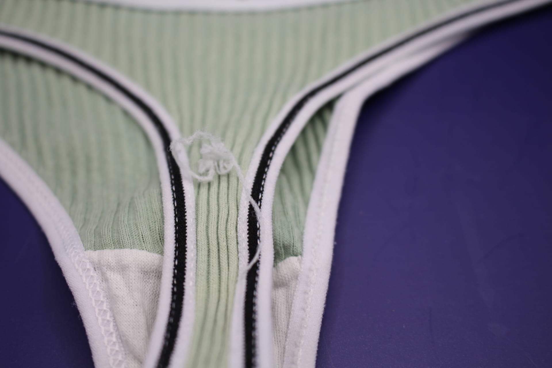 close-up of loose thread on green LOVE YOU panties for women from Temu