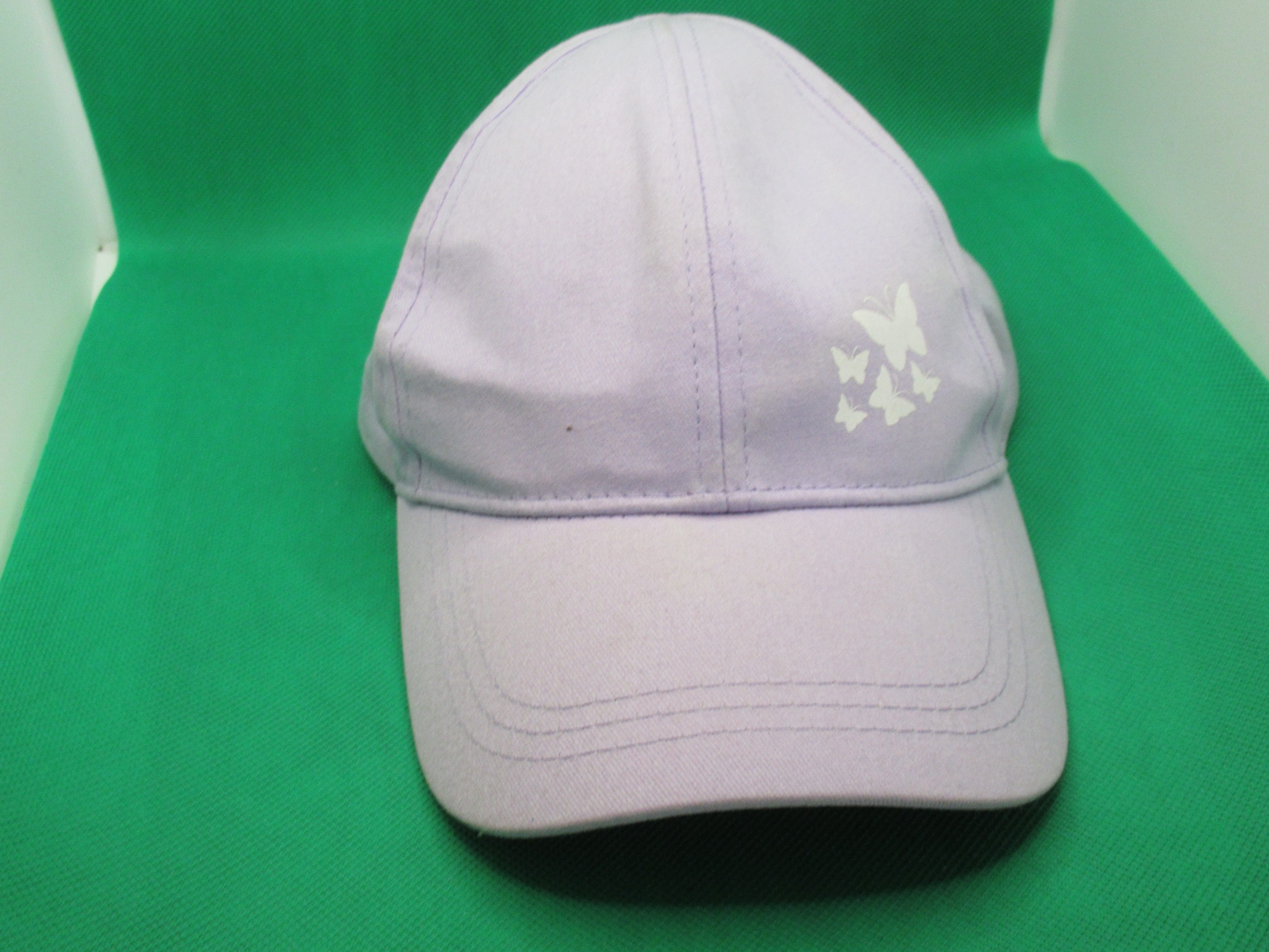 indented shape of hat stretcher in dome portion of baseball cap stretched by hat stretcher -- result of using hat stretcher in shaped baseball cap
