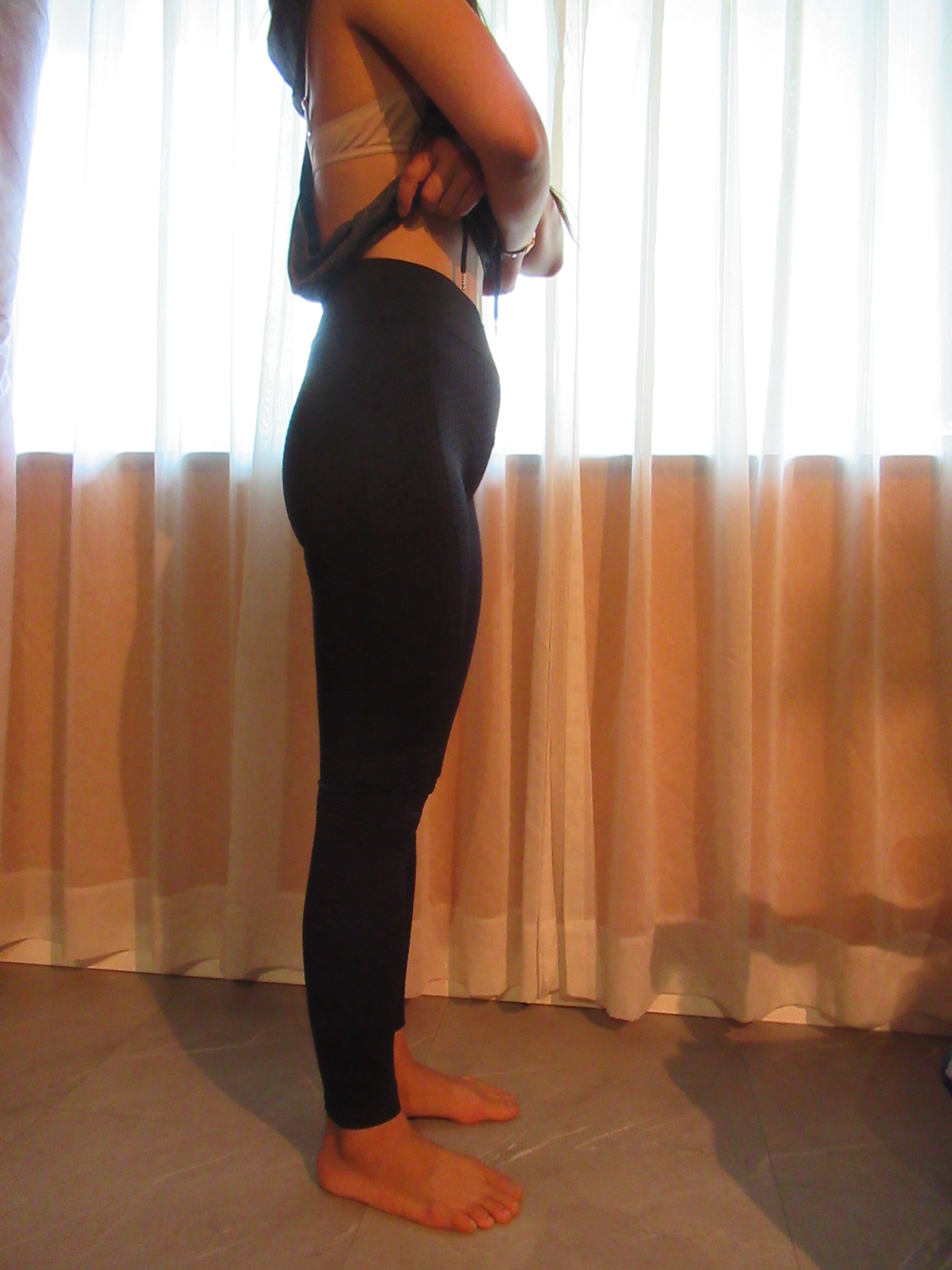 Honeycomb-textured scrunch butt butt-lifting pants -- black, right side view; trying on, modelling honeycomb-textured, scrunched butt-lifter on person