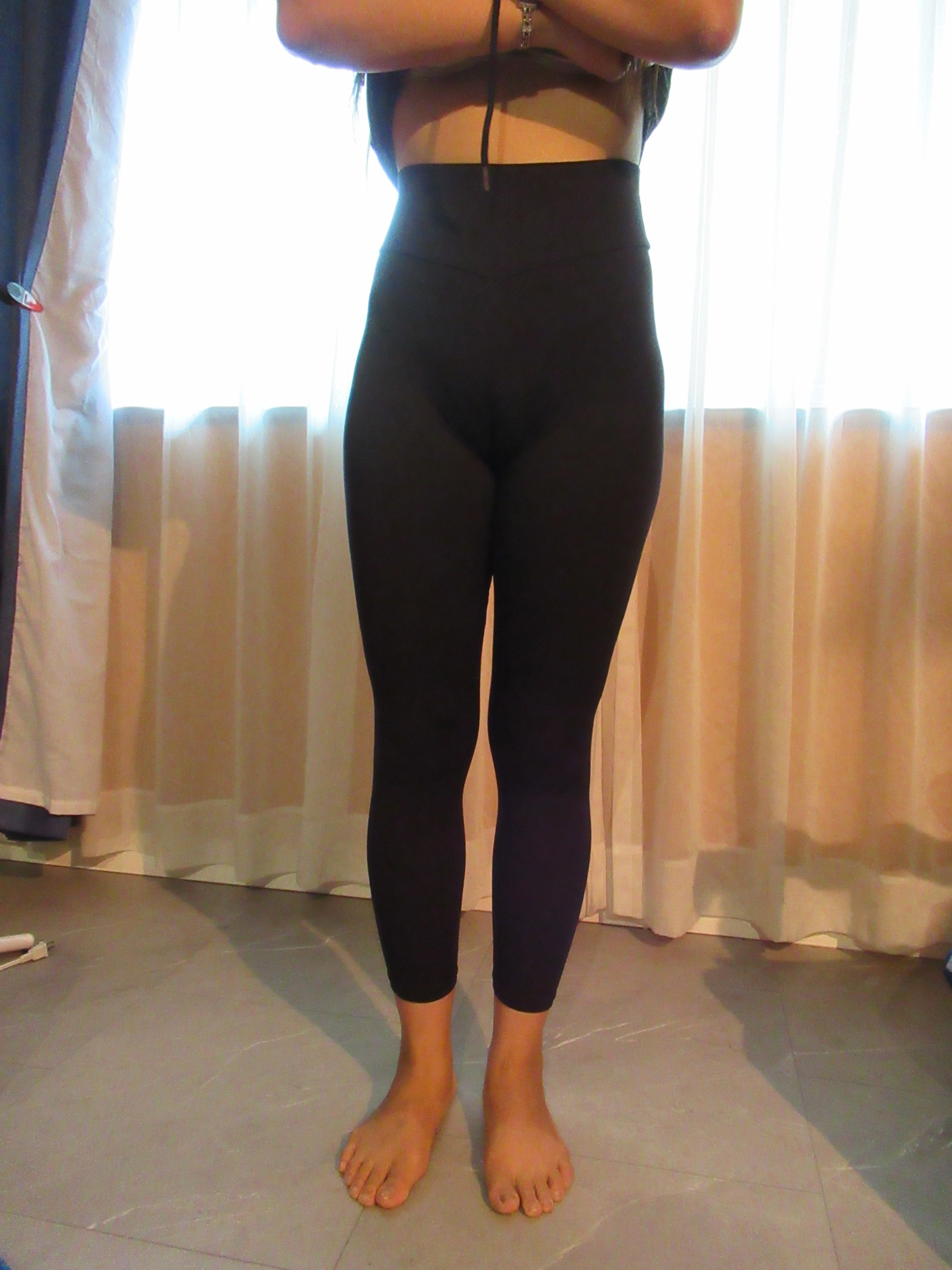 Booty scrunch butt-lifting pants with ruching -- black, front view; trying on, modelling "scrunch butt" ruched butt-lifter on person