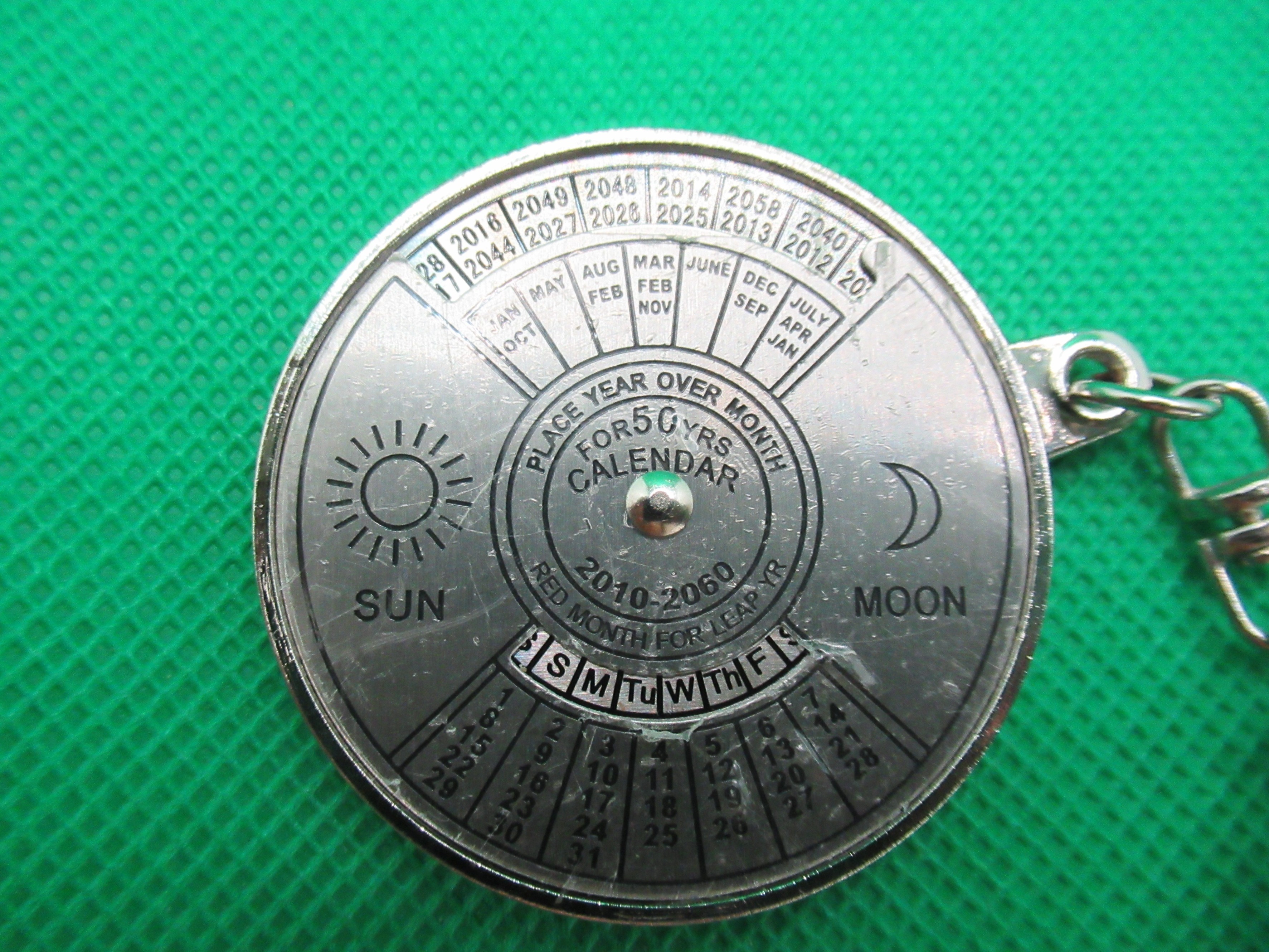 plastic covering protecting the face of the 50-year calendar keychain