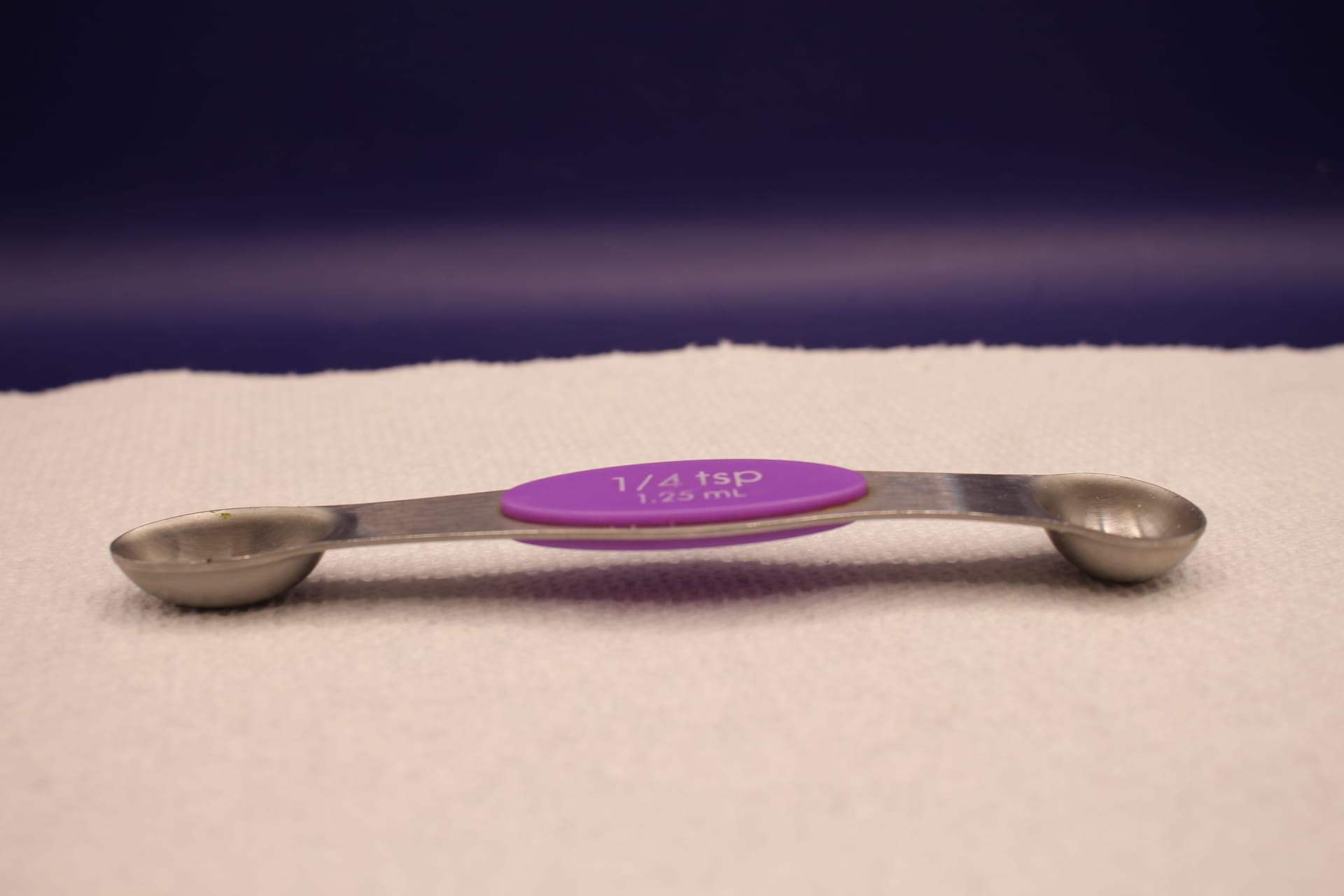 bent 1/4 tsp double sided measuring spoon, scoop side up