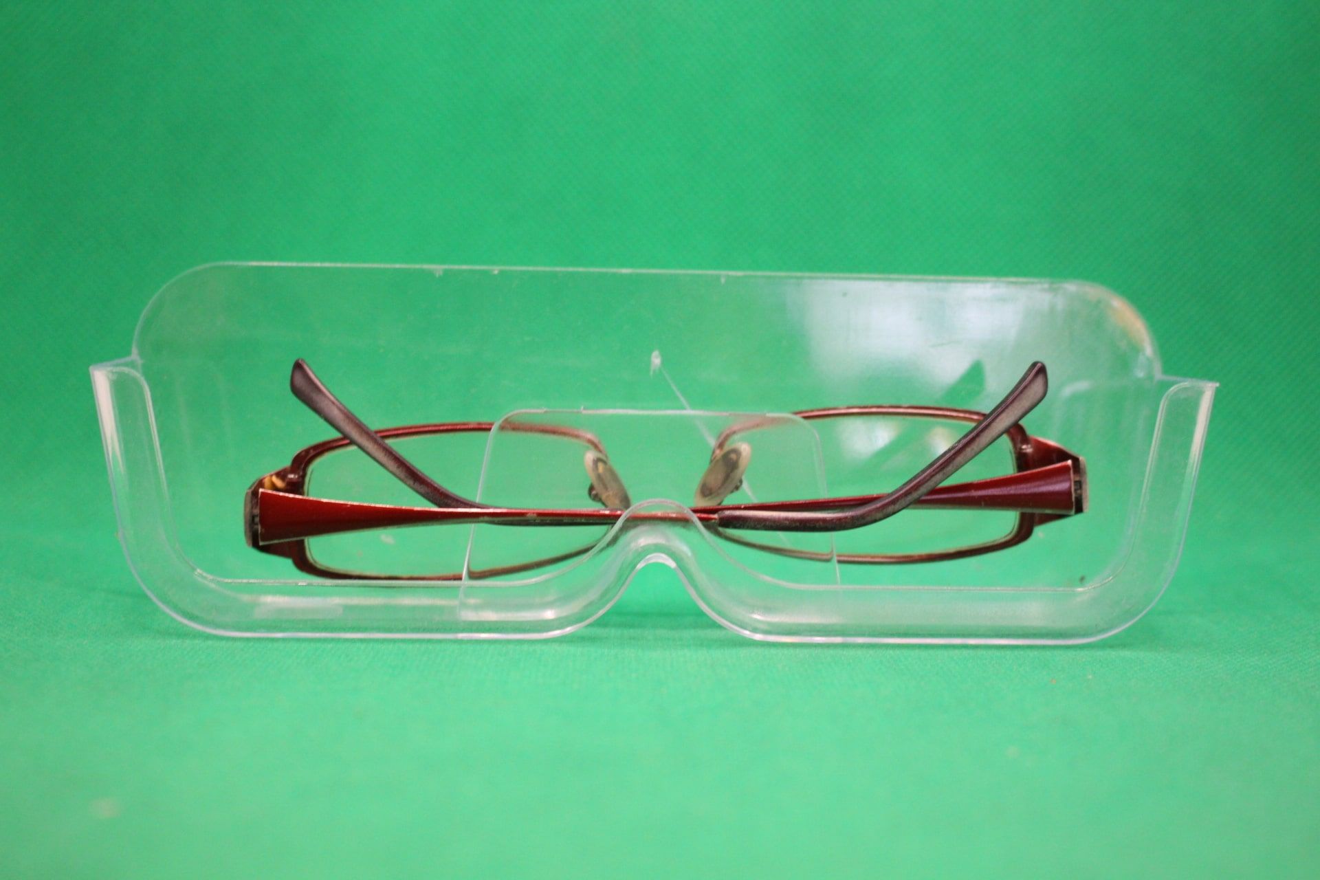 wall mounted eyeglasses holder with glasses in them, upside down