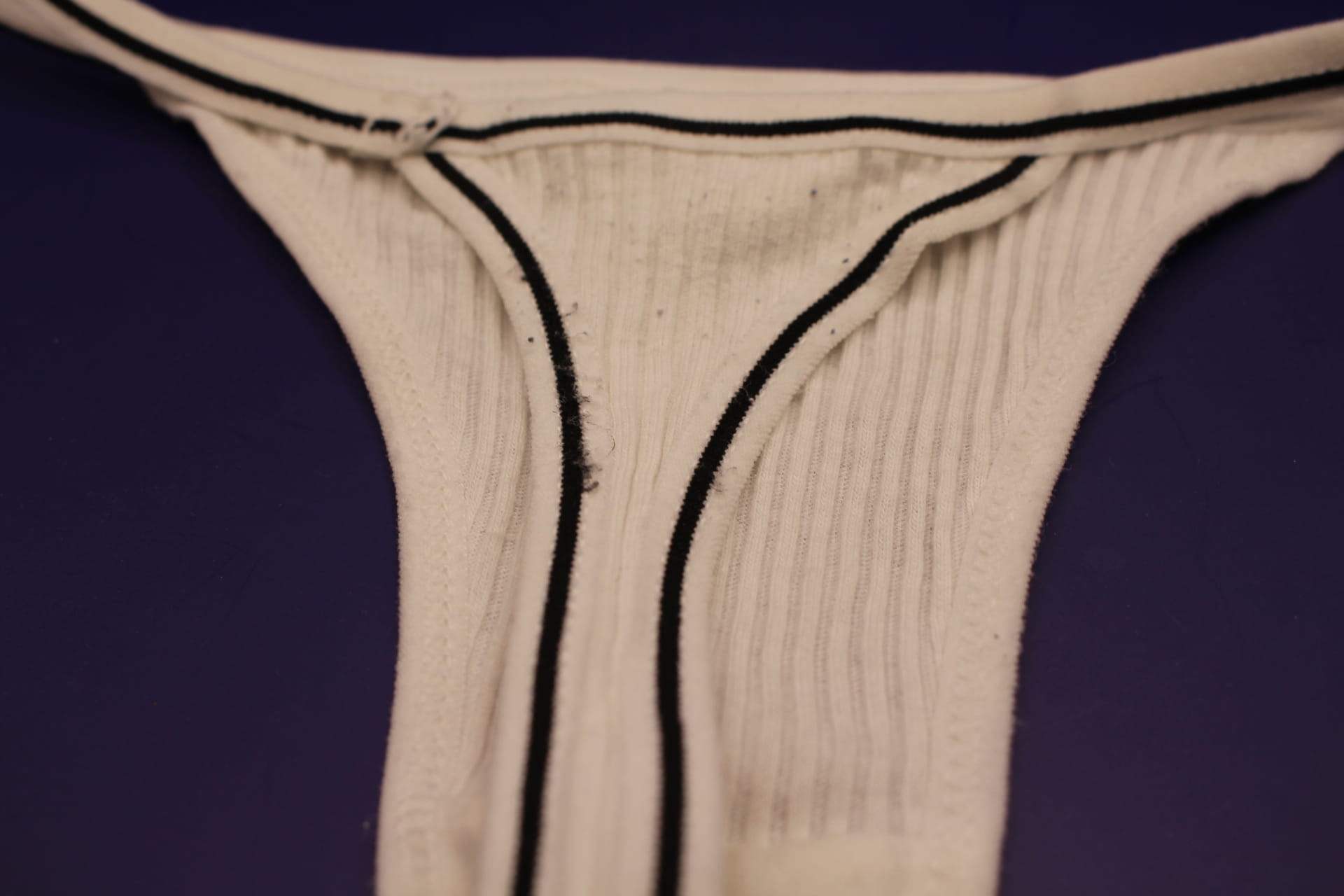 white cotton v string panty, back view close-up of thread coming loose