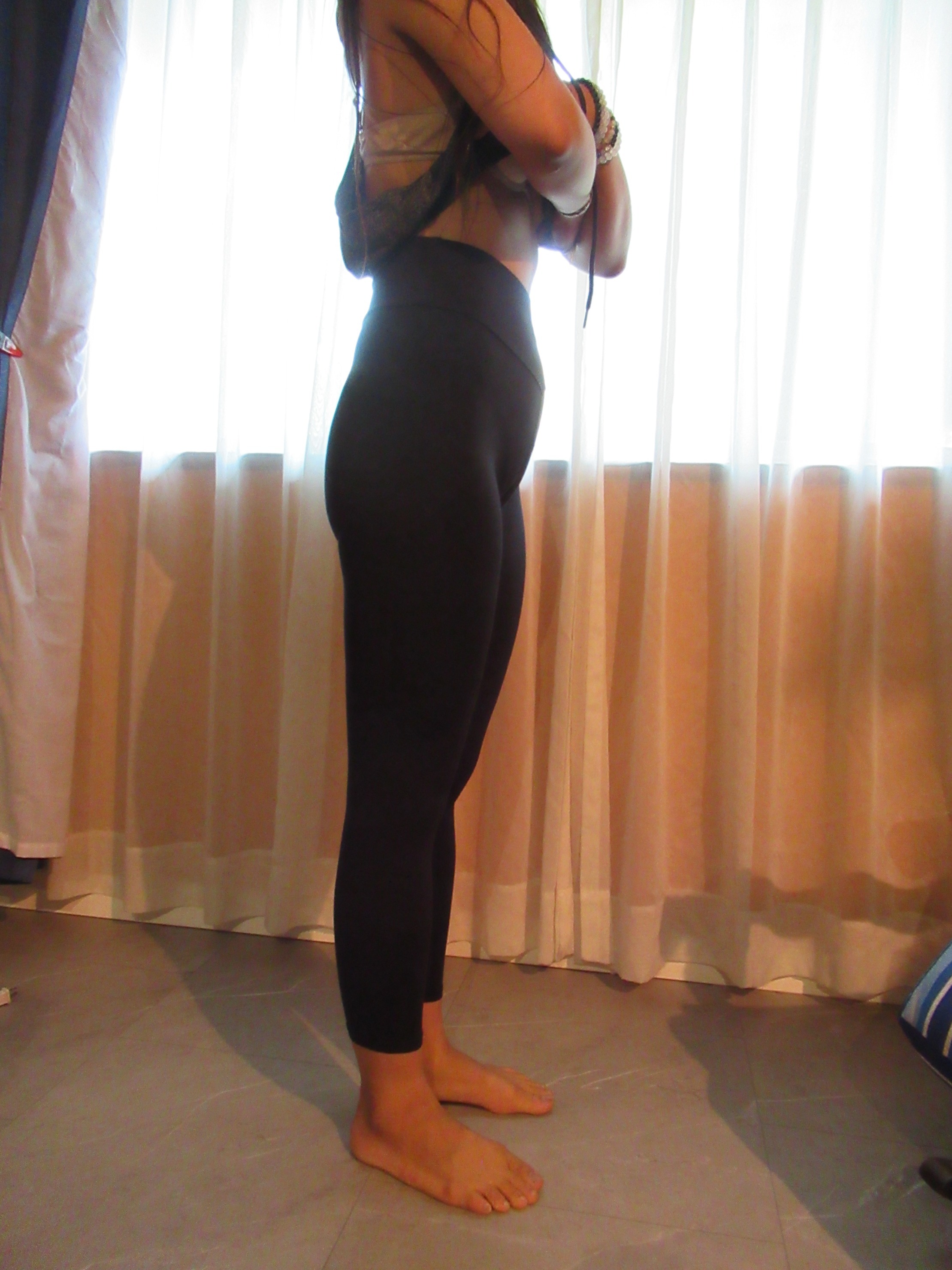 Booty scrunch butt-lifting pants with ruching -- black, right side view; trying on, modelling "scrunch butt" ruched butt-lifter on person