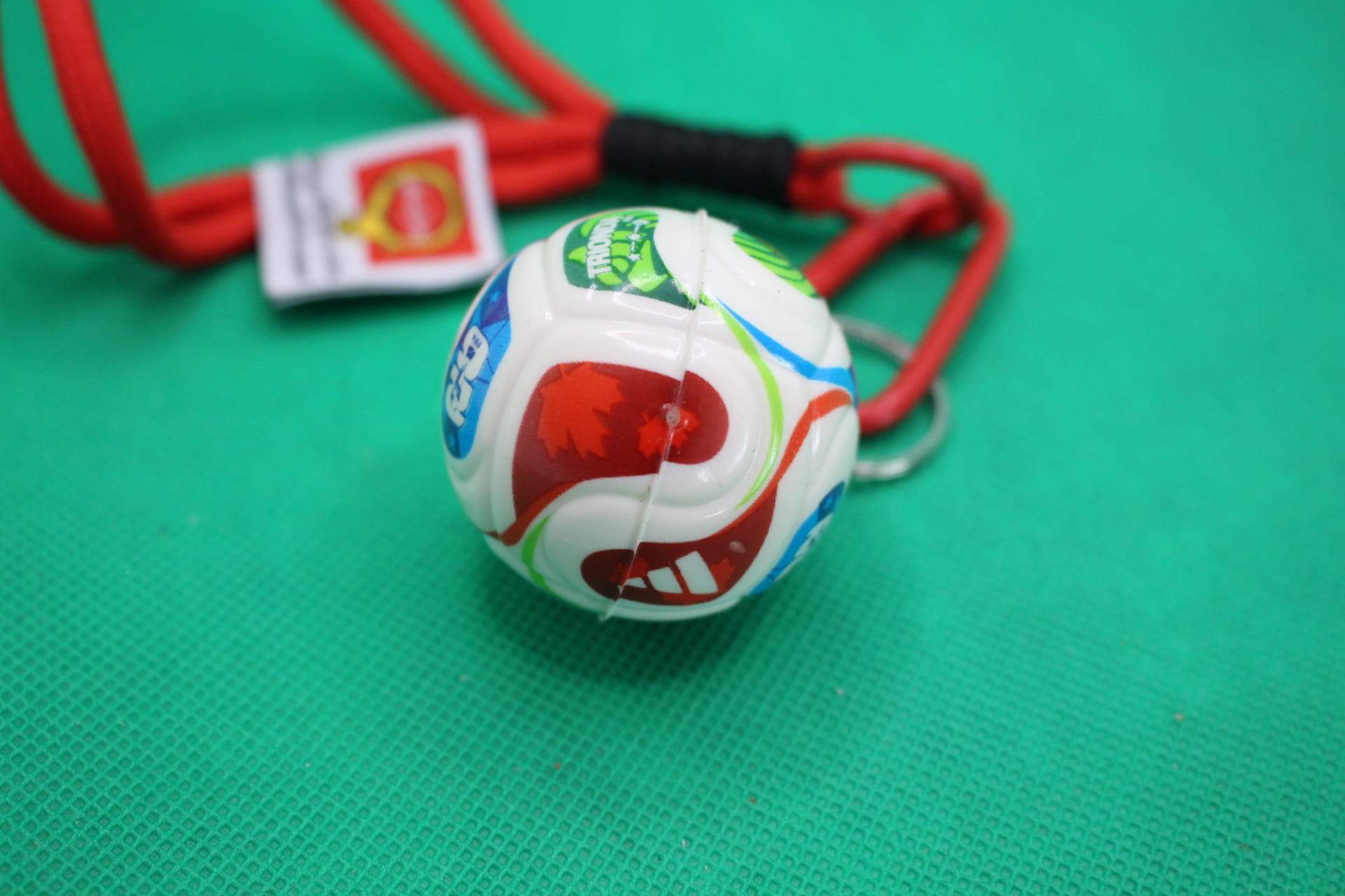 FIFA World Cup 2026 ball keychain, soccer ball focus, unaligned Canadian maple leaf section