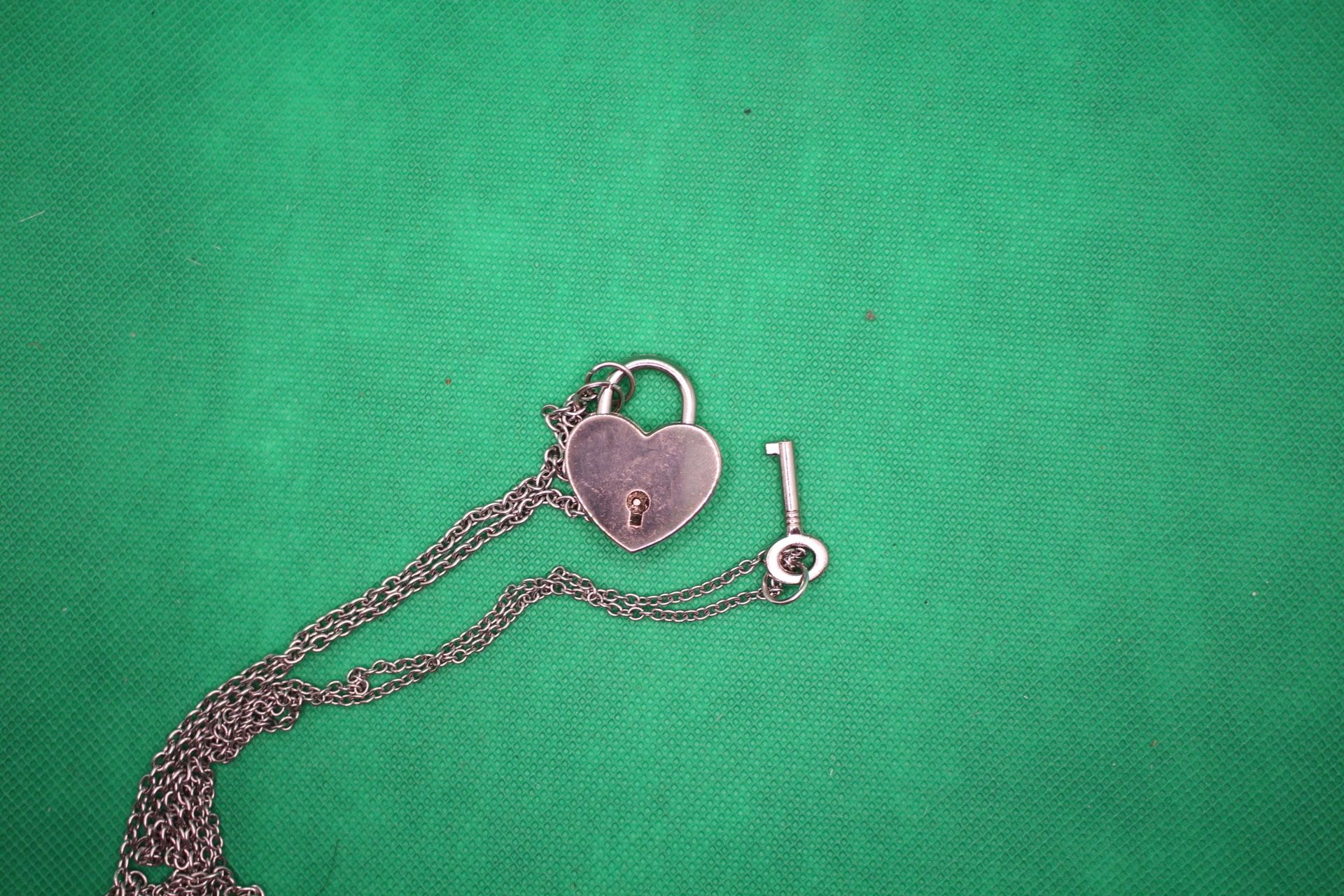 heart lock and key couple necklace set, close-up shot of pendants