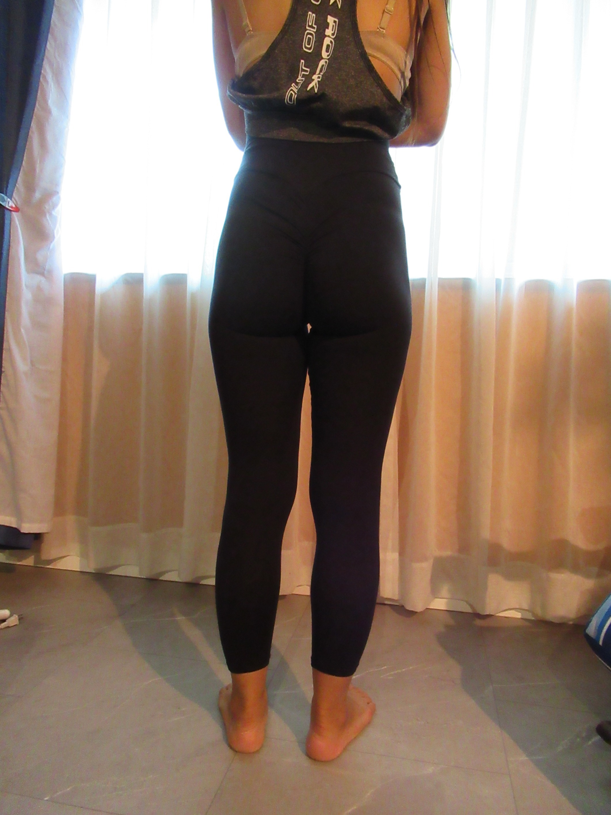 Booty scrunch butt-lifting pants with ruching -- black, back view; trying on, modelling "scrunch butt" ruched butt-lifter on person