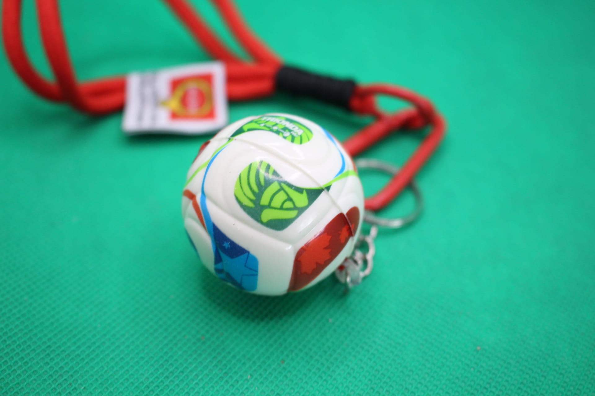 FIFA World Cup 2026 ball keychain, soccer ball focus, unaligned green section