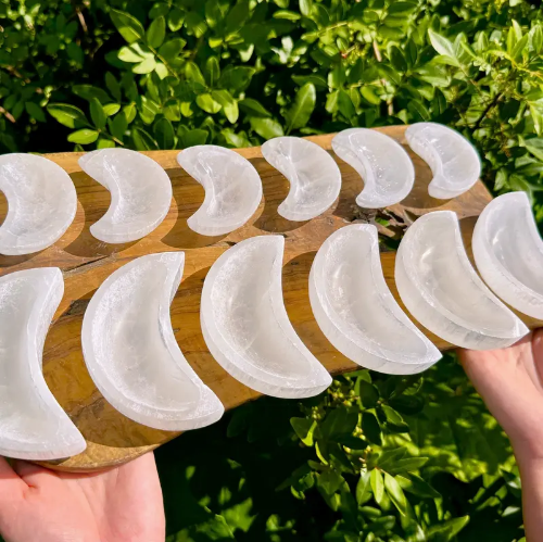 moon-shaped selenite crystal bowls of different sizes from Temu promo ad
