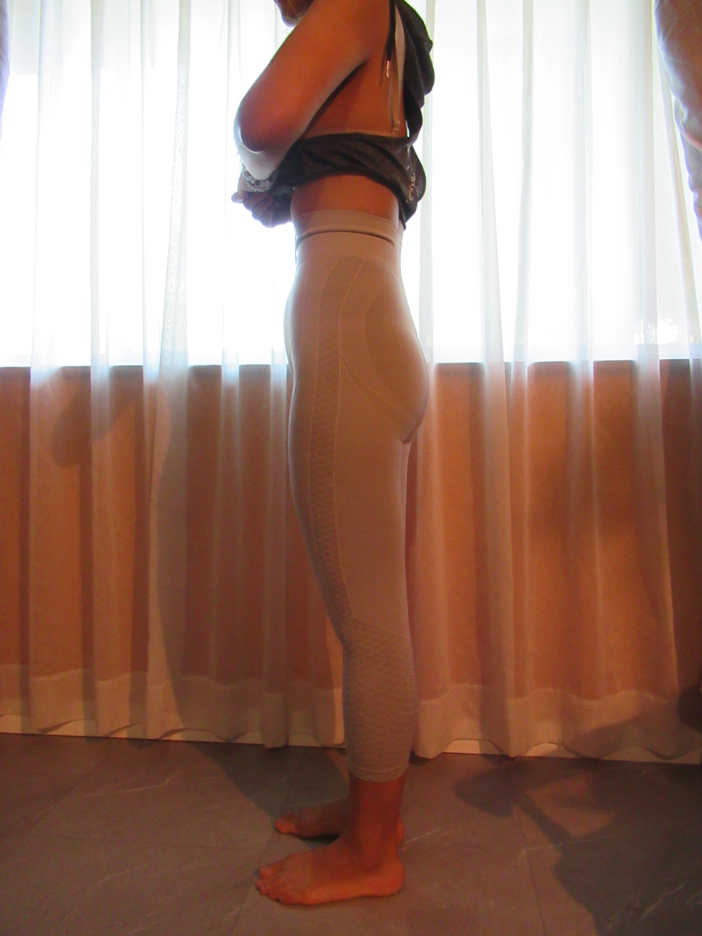 butt-lifting pants specifically designed to lift the butt, set of three -- white, left side view, trying on, modelling butt-lifters on person