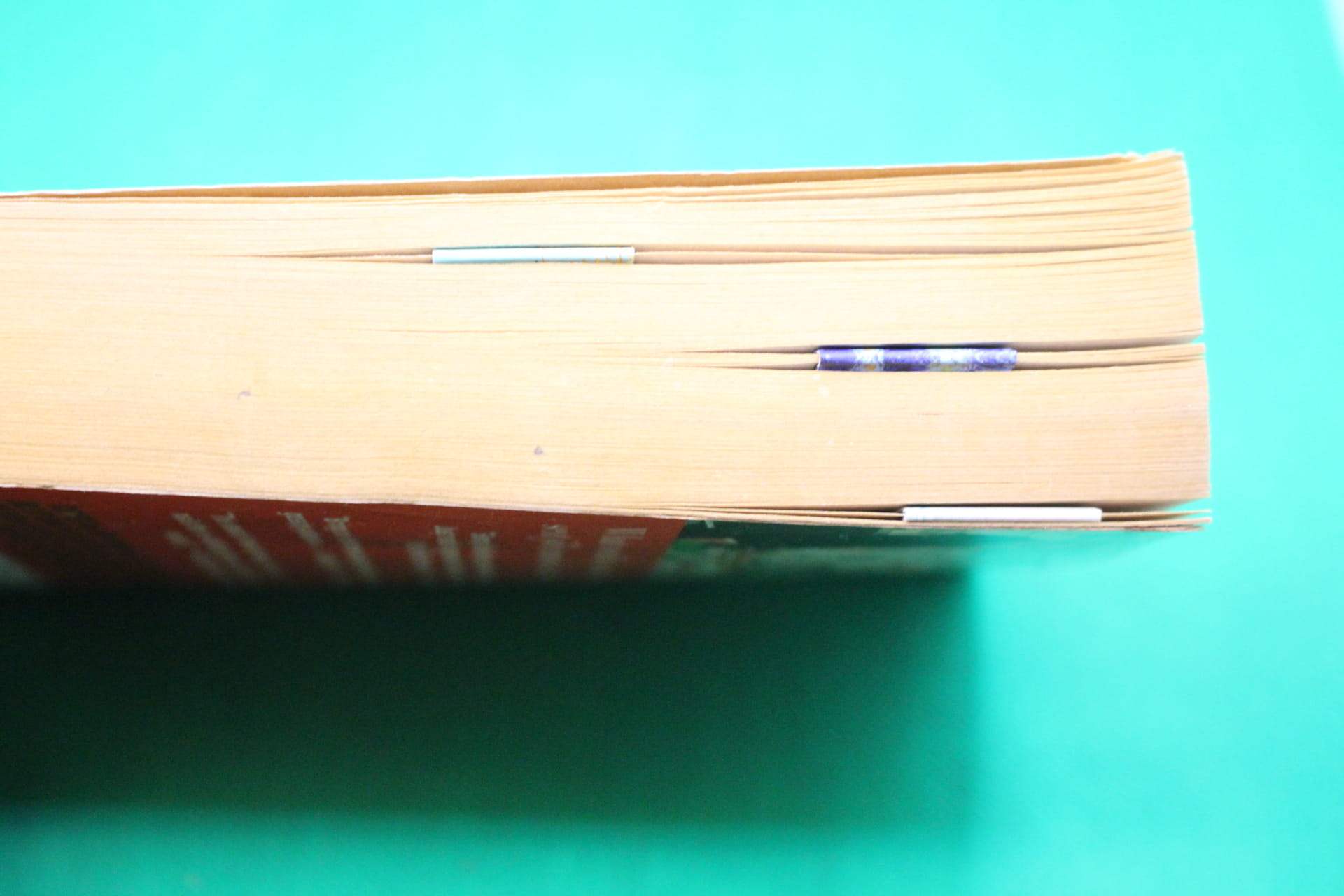 magnetic bookmark in book, shown from side to show thinness and how they can hold multiple pages together