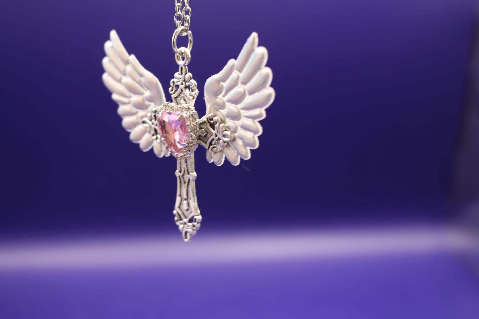 crystal angel wing pendant necklace, hanging, side view