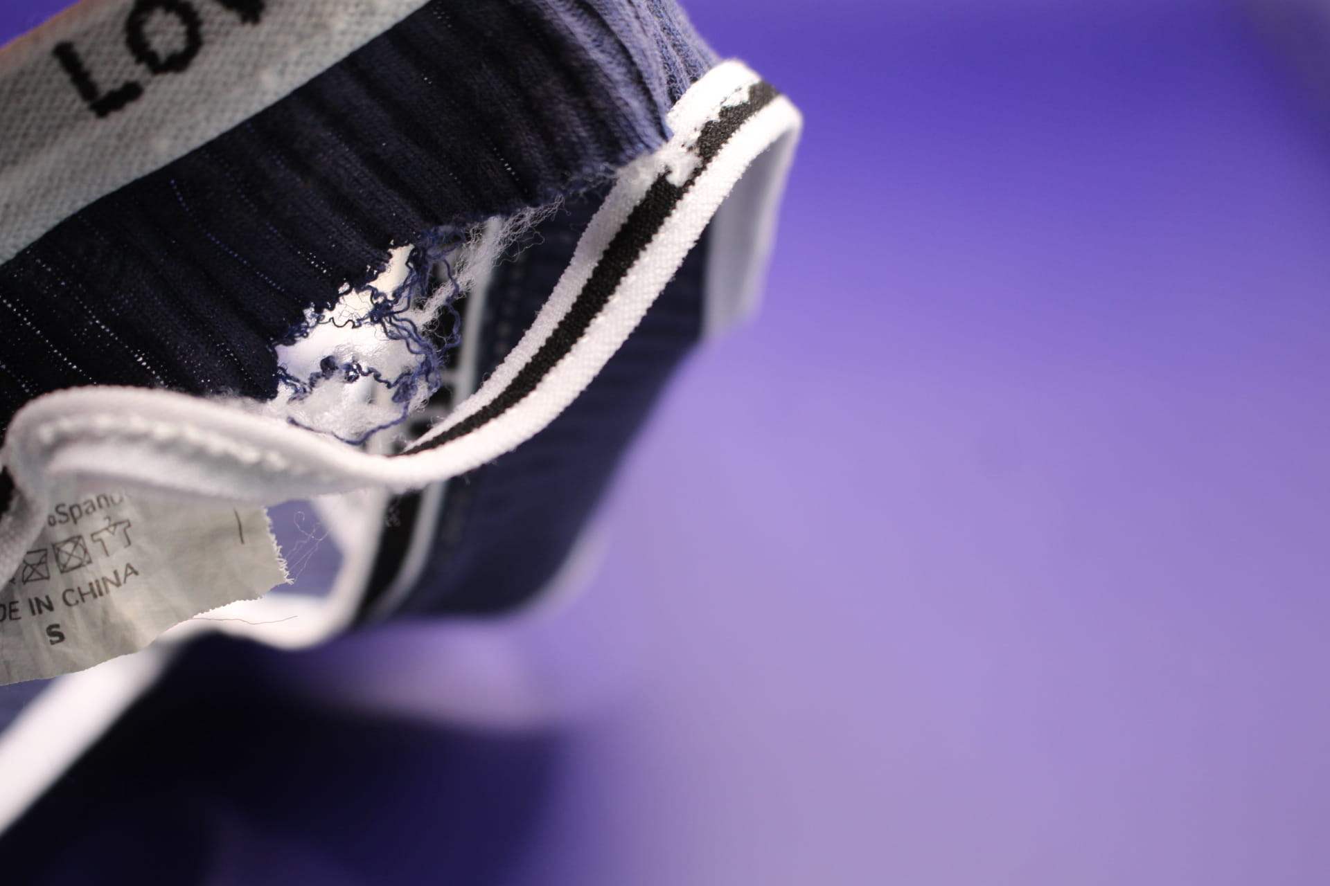 close-up of ripped band in navy blue LOVE YOU underwear from Temu