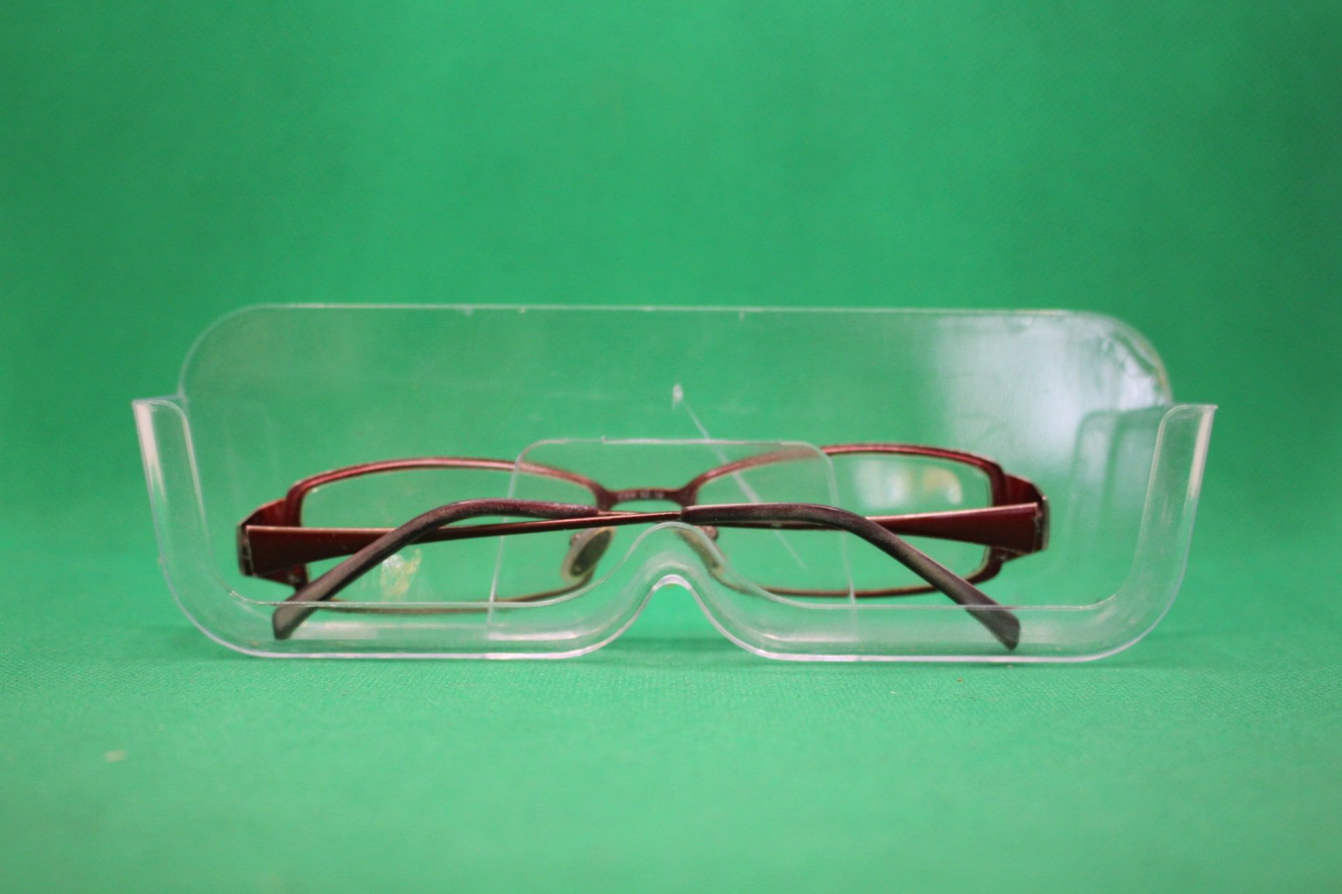 wall mounted eyeglasses holder with glasses in them, right-side up