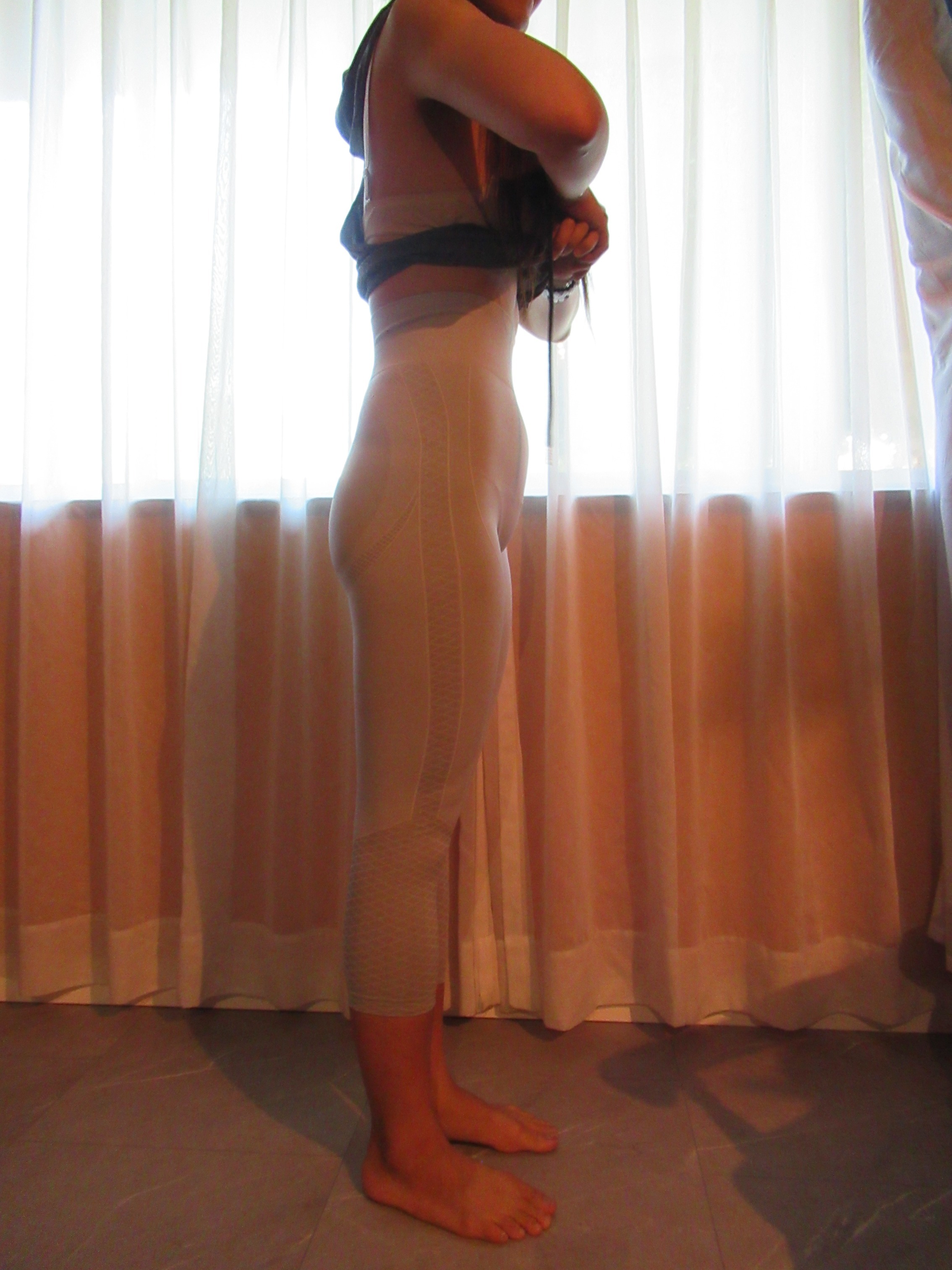 butt-lifting pants specifically designed to lift the butt, set of three -- white, right side view; trying on, modelling butt-lifters on person