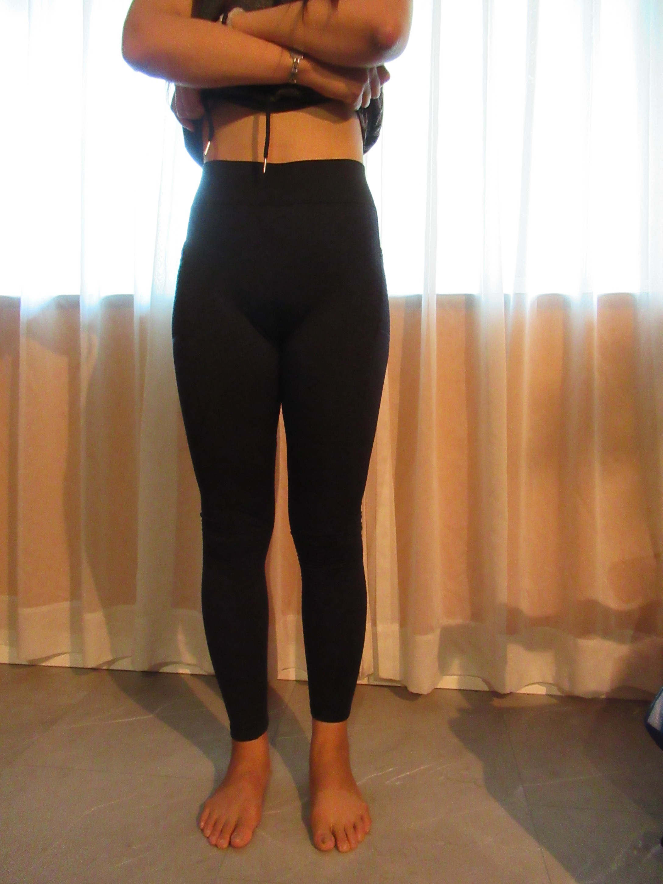 Honeycomb-textured scrunch butt butt-lifting pants -- black, front view; trying on, modelling honeycomb-textured, scrunched butt-lifter on person