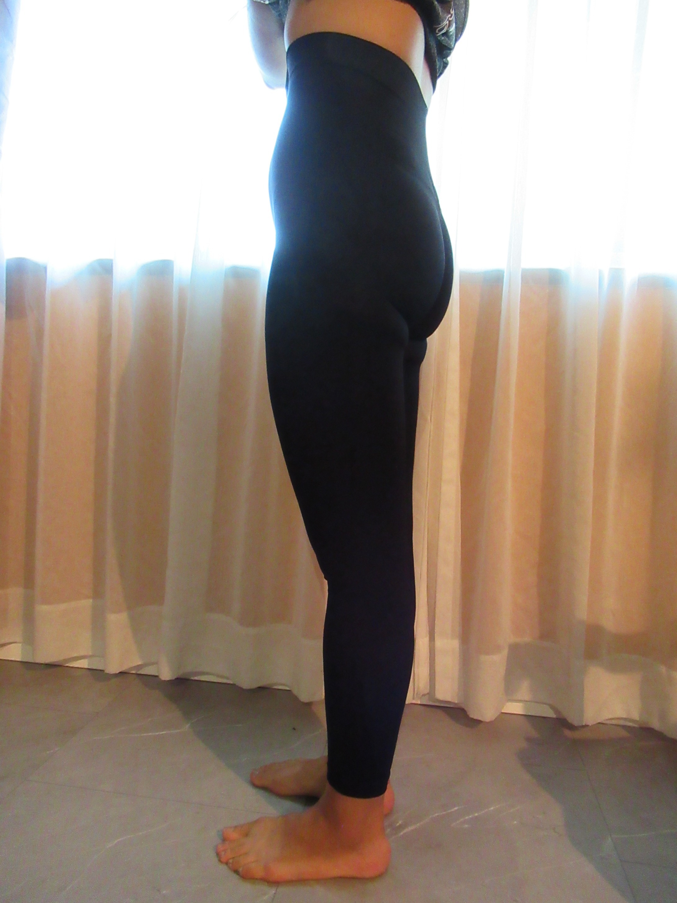 peach lift butt-lifting leggings --  black, left side view; trying on, modelling peach-lift butt-lifter on person